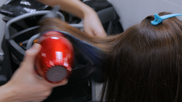 Professional Hairdresser Drying Client Hair