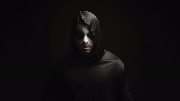 Young Man with Scary Make Up Dressed Up Like Grim Reaper alt
