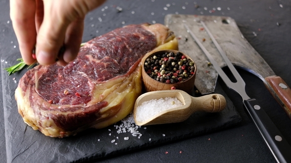 Marbling Ribeye Steak on Black Plate