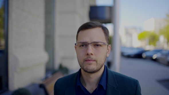 Happy Attractive Caucasian Businessman Walking Outside Near Big Office Building and Looking Around alt