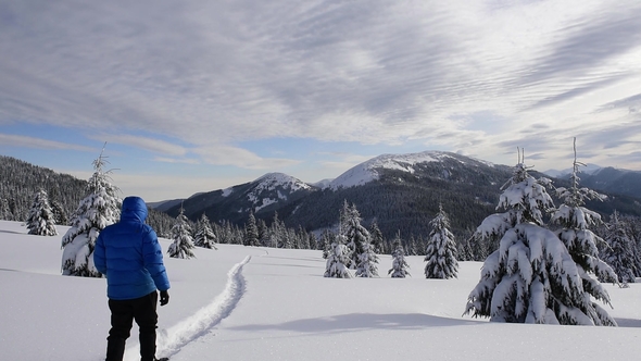 Alone Tourist in the High Mountains in Winter Time