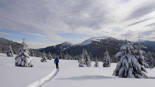 Alone Tourist in the High Mountains in Winter Time