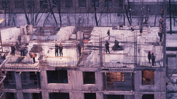 Workers on the Top of the Building under Construction