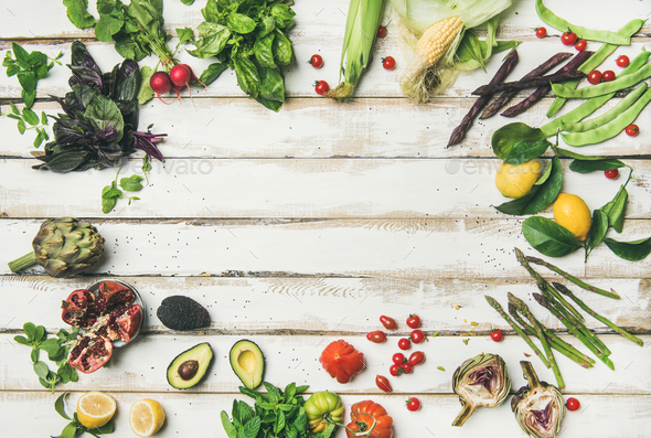 Healthy raw summer vegan ingredients over white wooden background - Stock Photo - Images