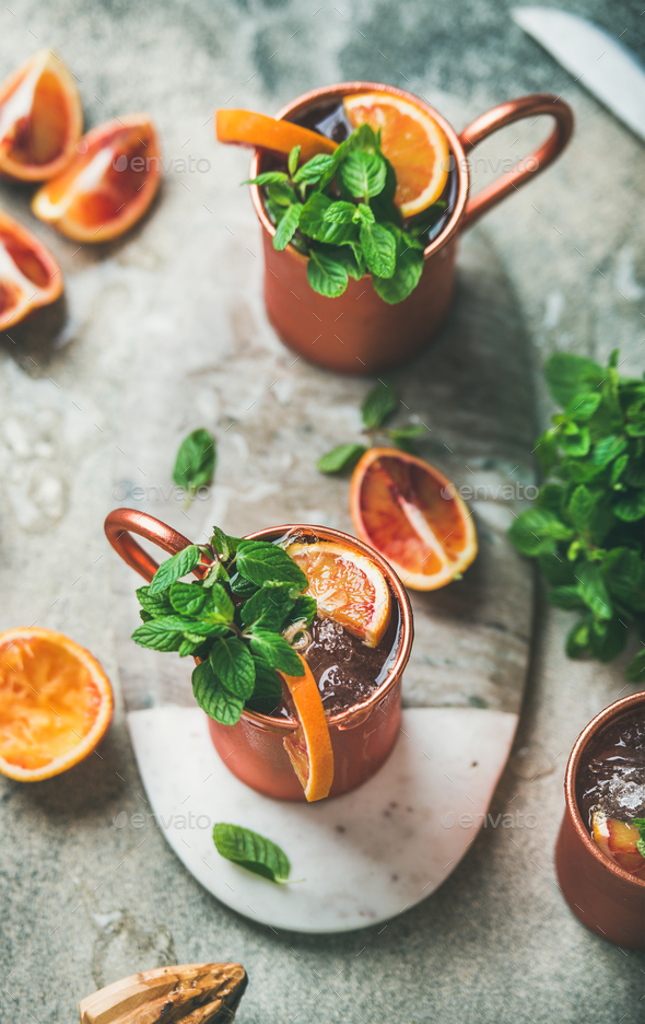 Blood orange Moscow mule alcohol cocktails in metal mugs - Stock Photo - Images