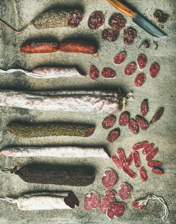 Variety of Spanish or Italian cured sausages cut in slices - Stock Photo - Images
