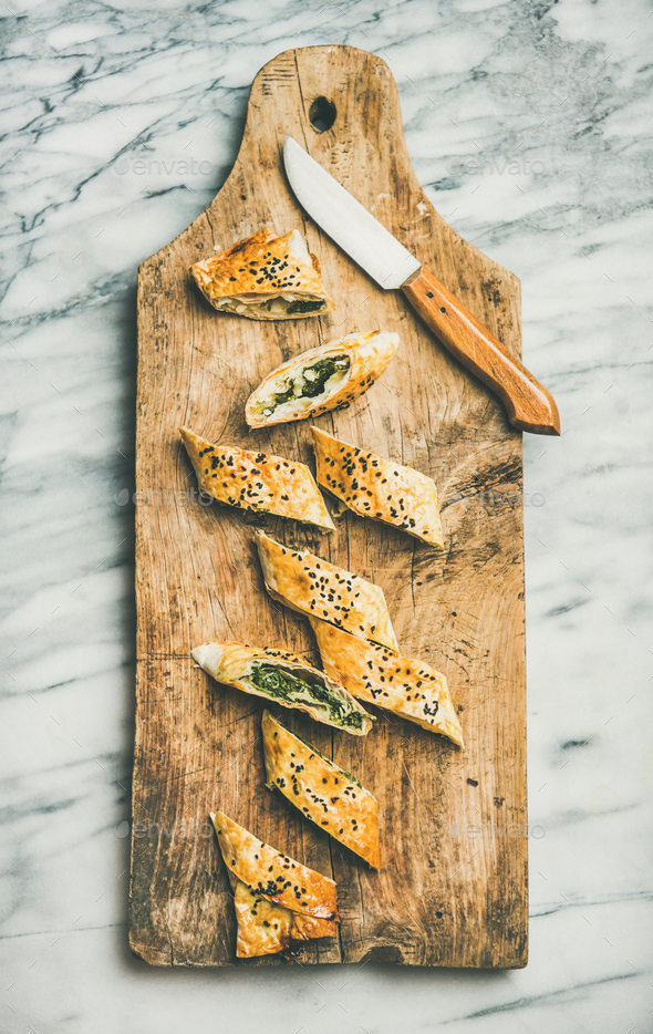 Freshly baked Turkish borek roll slices with cheese and spinach - Stock Photo - Images