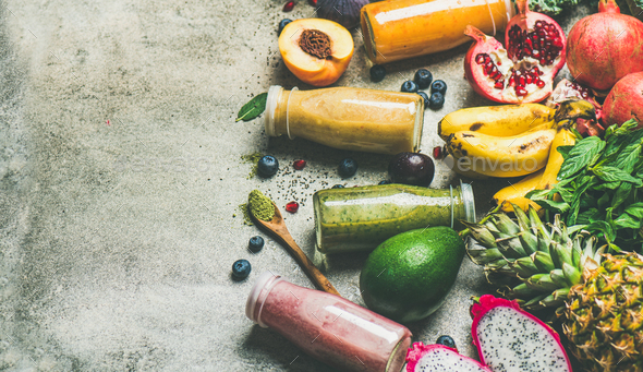 Colorful smoothies in bottles with fresh fruit, copy space - Stock Photo - Images