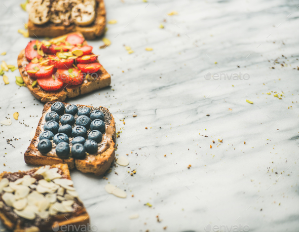 Vegan whole grain toasts with fruit, seeds, nuts, selective focus - Stock Photo - Images