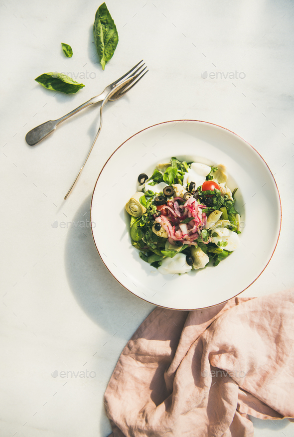 Fresh green summer salad with artichokes, top view - Stock Photo - Images