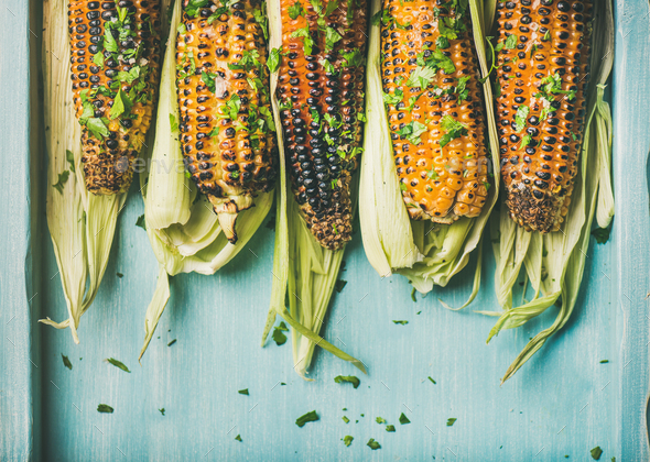 Grilled sweet corn with pesto sauce and herb, copy space - Stock Photo - Images