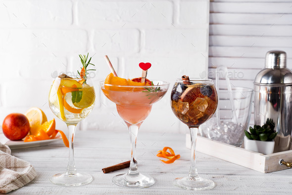 Different alcoholic drink in glass with Bar accessories on white wooden background - Stock Photo - Images