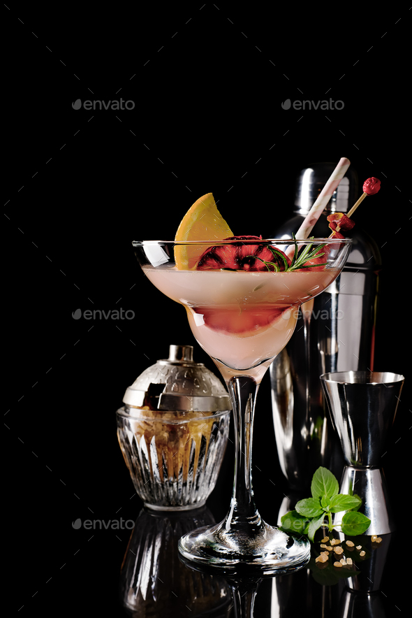 Refreshing alcoholic cocktail margarita with citrus fruits on black glass background - Stock Photo - Images