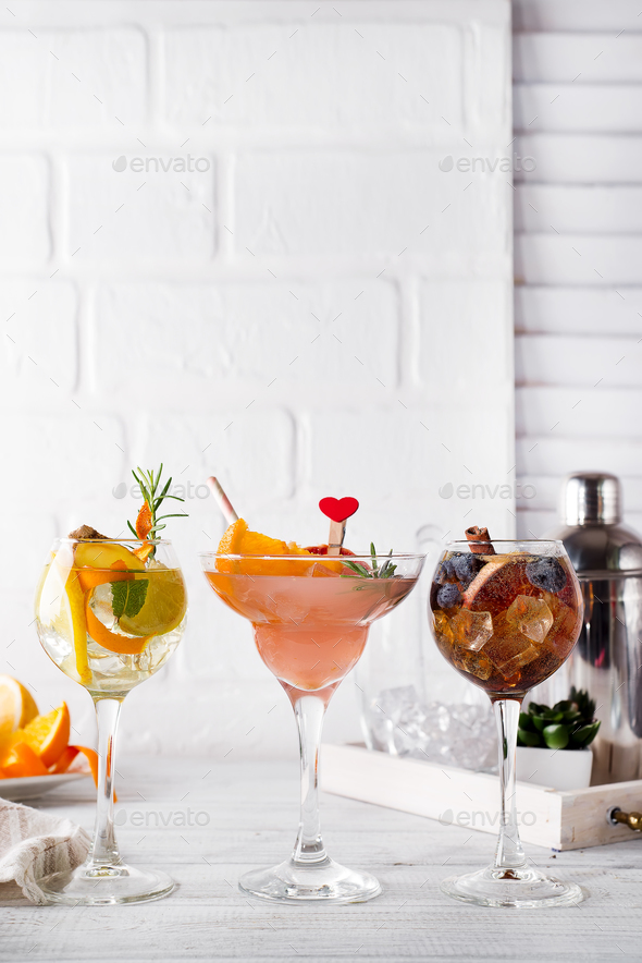 Different alcoholic drink in glass with Bar accessories on white wooden background - Stock Photo - Images