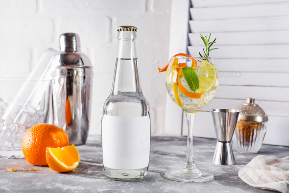 Alcohol drink (gin tonic cocktail) with lemon, rosemary and ice - Stock Photo - Images