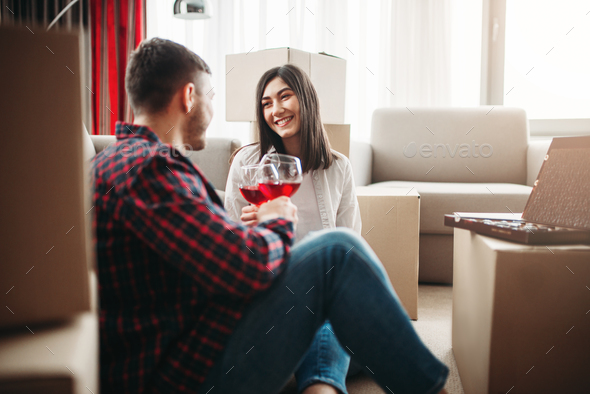 Happy couple celebrate moving to new house - Stock Photo - Images