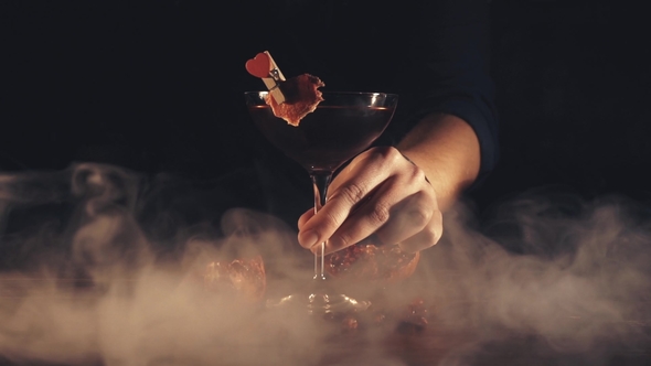 Barman Serves a Cocktail at the Bar