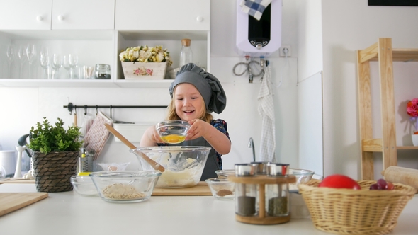 Little Girl Baker Puts Butter To the Pastry Dough for Cooking Biscuits alt