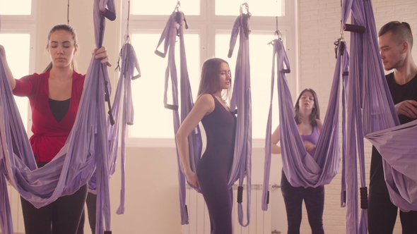 Group of People Doing Aerial Yoga in Gym