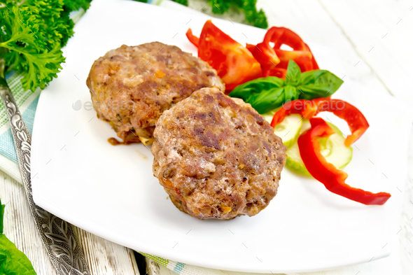 Cutlets stuffed with basil in plate on light board - Stock Photo - Images