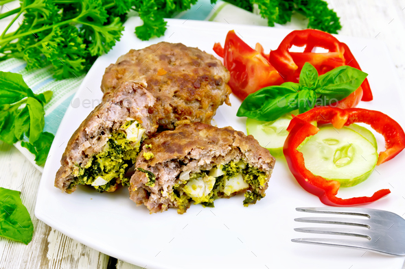 Cutlets stuffed with vegetables in plate on board - Stock Photo - Images