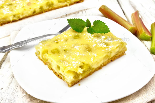 Kukhen with rhubarb and pudding in plate on wooden board - Stock Photo - Images