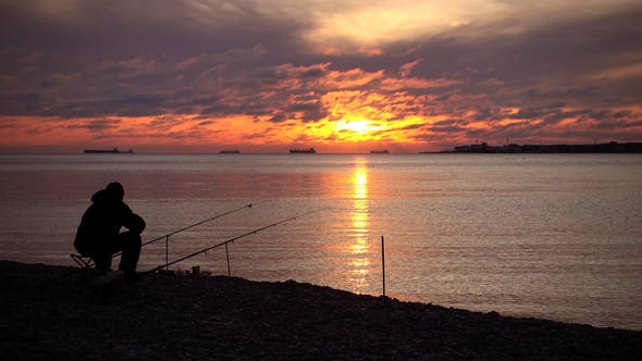Fisherman Caught a Fish Majestic Sunset Over Water