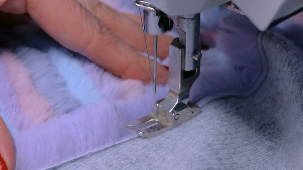 Tailor Sewing Fur Coat with Sewing Machine