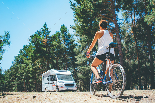 Motor home and girl with bicycle - Stock Photo - Images