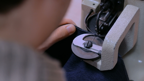 Skinner Using Sewing Machine for Stitching Fur Skin at Atelier