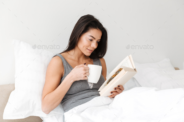 Portrait of pleased peaceful woman with long brown hair resting - Stock Photo - Images
