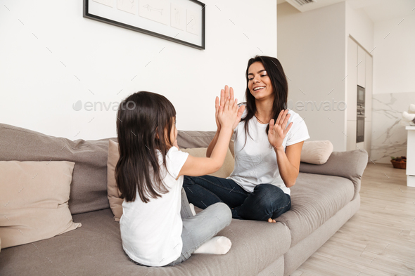 Picture of happy people woman and little child playing together Stock Photo by vadymvdrobot