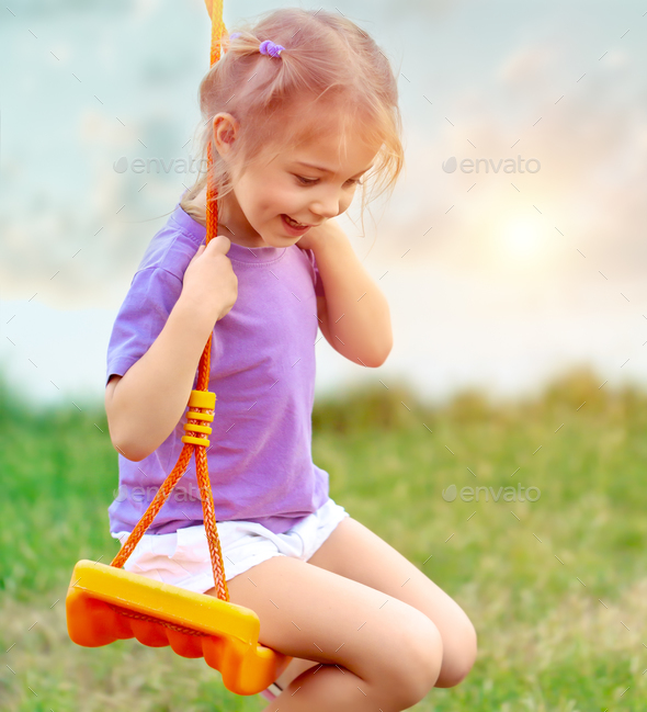 Cute baby girl on the swing - Stock Photo - Images