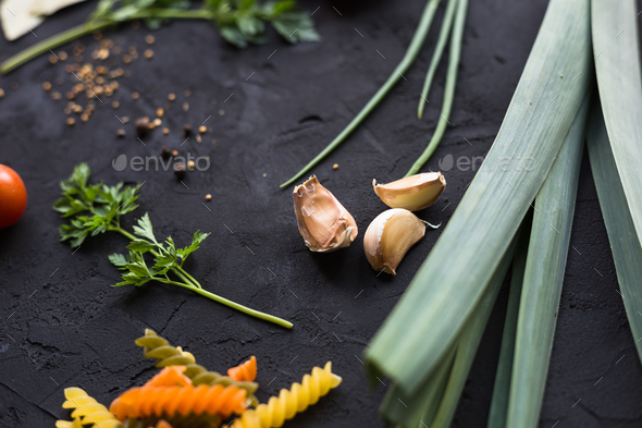 Fresh ingredients for cooking pasta, tomatoes, onions, garlic, herbs - Stock Photo - Images