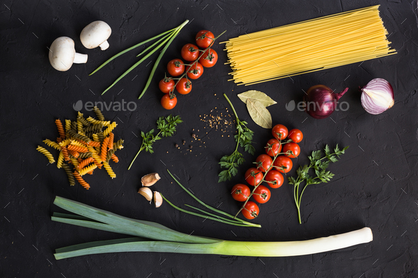 Fresh ingredients for cooking pasta, tomatoes, onions, garlic, herbs - Stock Photo - Images