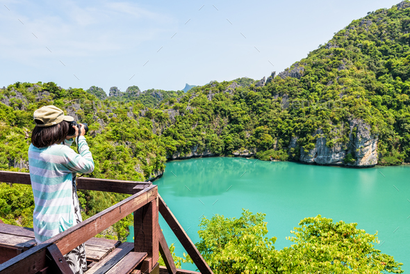 Woman tourist taking photos of Thale Nai - Stock Photo - Images