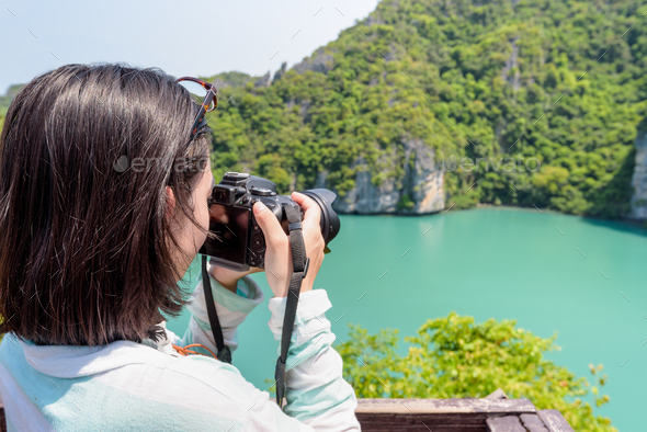 Woman tourist taking photos of Thale Nai - Stock Photo - Images