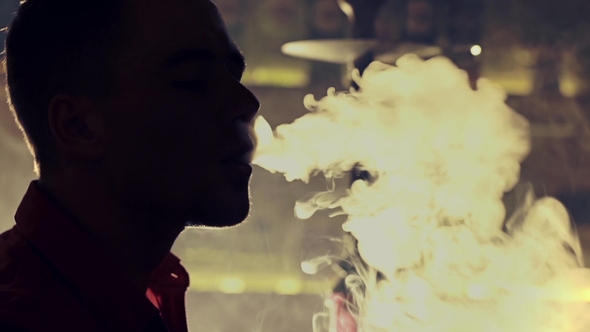Young Man Smoking Hookah at a Bar