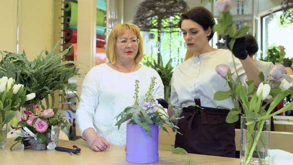 Two Florists Make Flower Composition in Flower Shop alt