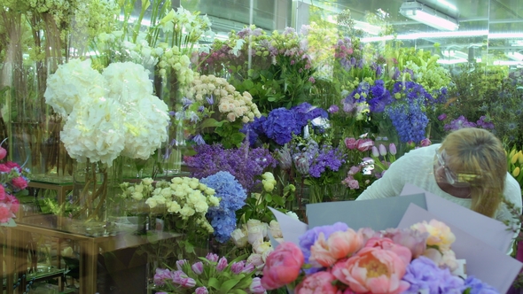 Mature Woman Choose Flowers in Flower Shop alt