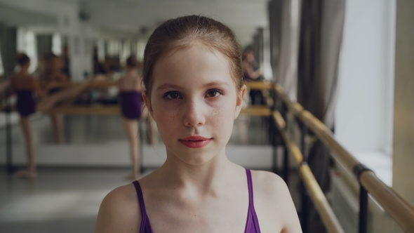 Portrait of Young Girl Starting Ballet-dancer with Make-up Looking at Camera and Smiling alt