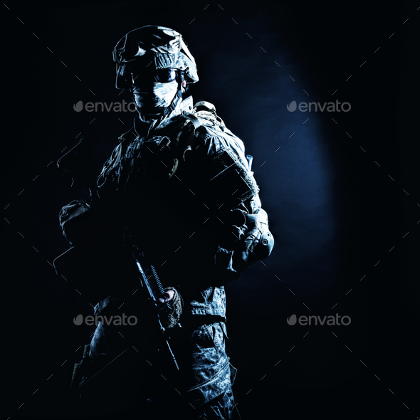 Infantry rifleman standing with weapon in darkness - Stock Photo - Images