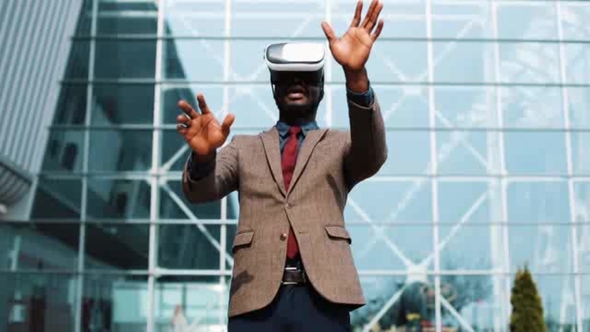 African American Businessman Plays in VR Headset Standing Outside ...