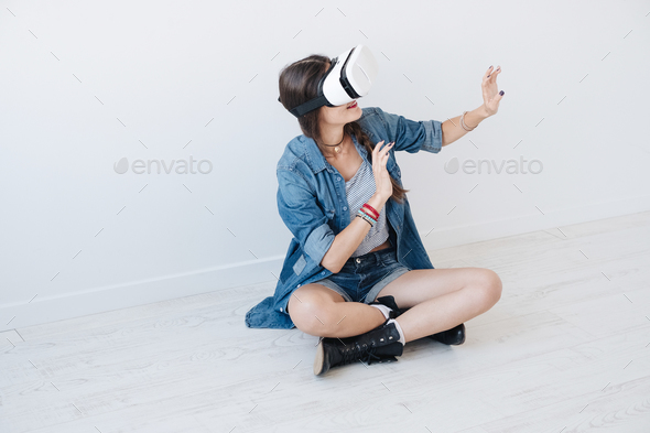 Woman using VR device in studio - Stock Photo - Images