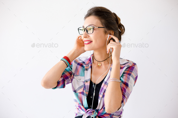 Lovely young woman looking to right enjoy music - Stock Photo - Images