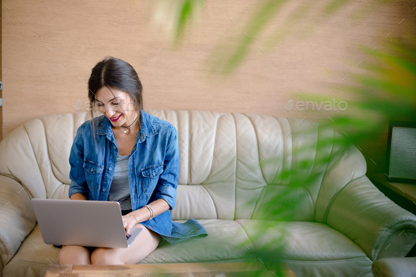 Smiling beautiful woman working on laptop - Stock Photo - Images