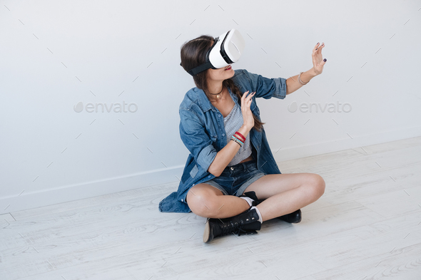 Woman using VR device in studio - Stock Photo - Images