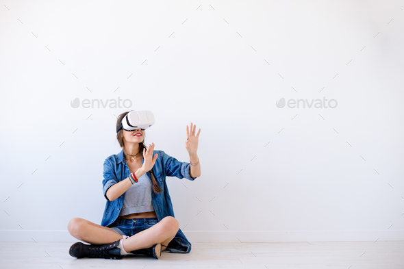 Smiling young woman use VR glasses - Stock Photo - Images