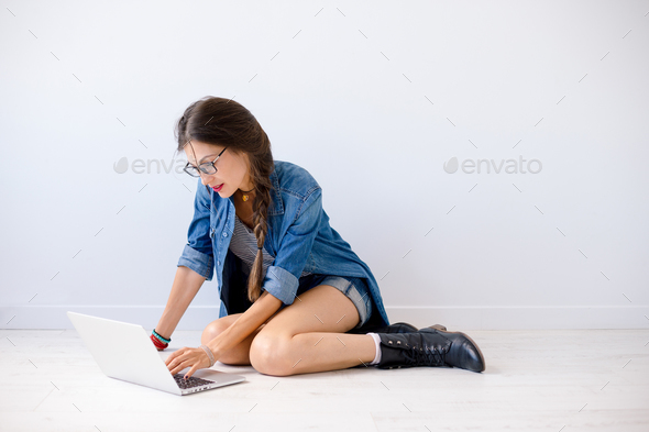 Smiling woman typing on laptop - Stock Photo - Images