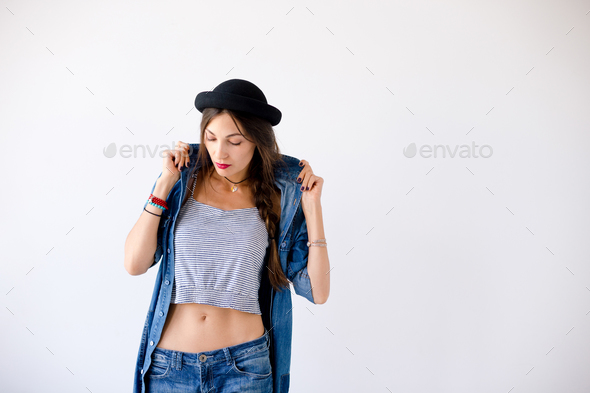 Attractive woman holding shirt collar with hands - Stock Photo - Images
